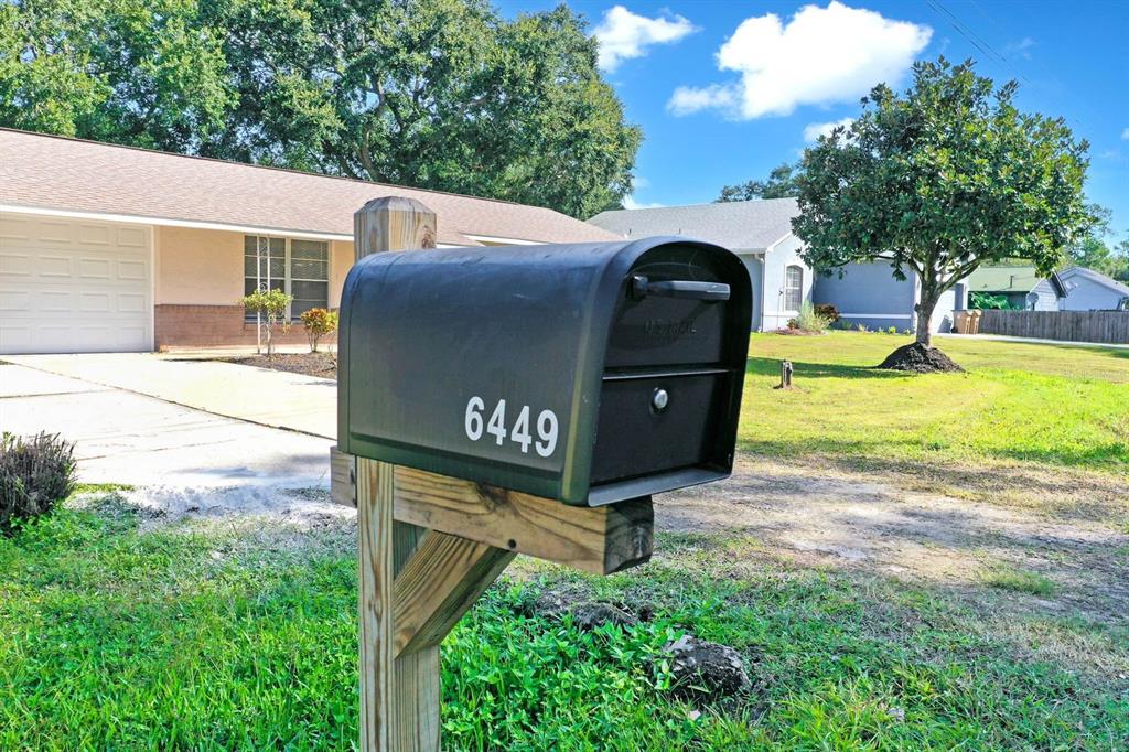 6449 Eve Street St. Cloud, FL 34771 - Photo 20 of 25 a front view of a house with garden