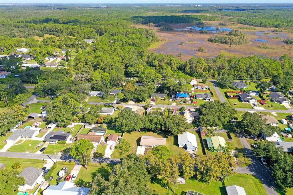 6449 Eve Street St. Cloud, FL 34771 - Photo 24 of 25 an aerial view of residential houses with outdoor space and trees