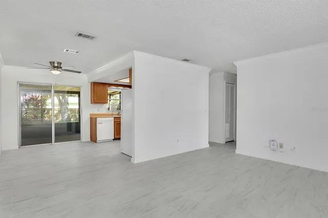 a view of an empty room with a kitchen