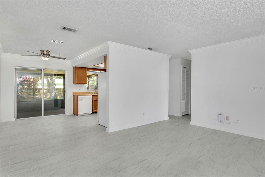 6449 Eve Street St. Cloud, FL 34771 - Photo 4 of 25 a view of an empty room with a kitchen