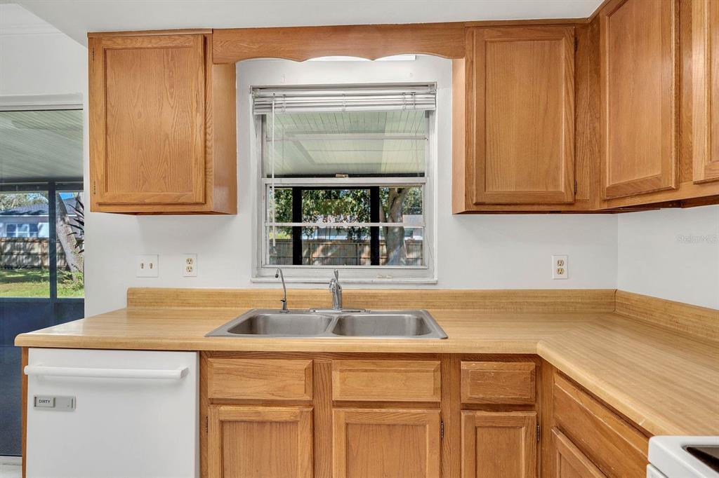 6449 Eve Street St. Cloud, FL 34771 - Photo 7 of 25 a kitchen with a sink and cabinets