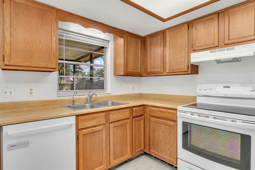 6449 Eve Street St. Cloud, FL 34771 - Photo 8 of 25 a kitchen with a sink stove and cabinets