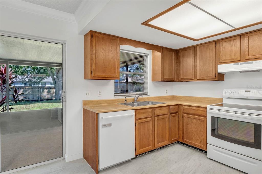6449 Eve Street St. Cloud, FL 34771 - Photo 9 of 25 a kitchen with a sink stove and cabinets