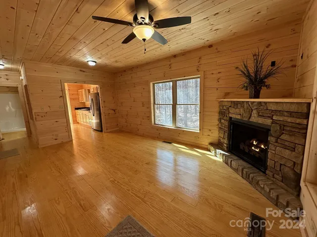 a living room with a fireplace wooden floor and a fireplace