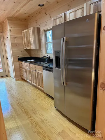 a kitchen with stainless steel appliances a refrigerator and a stove