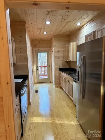 a kitchen with stainless steel appliances a stove a microwave and a microwave