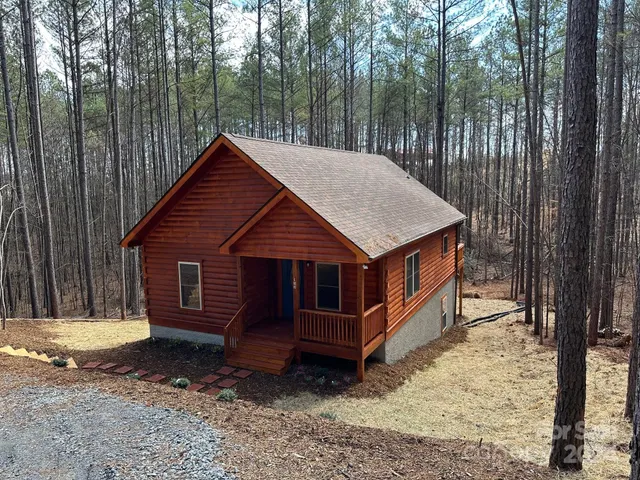 a view of a small house in the forest