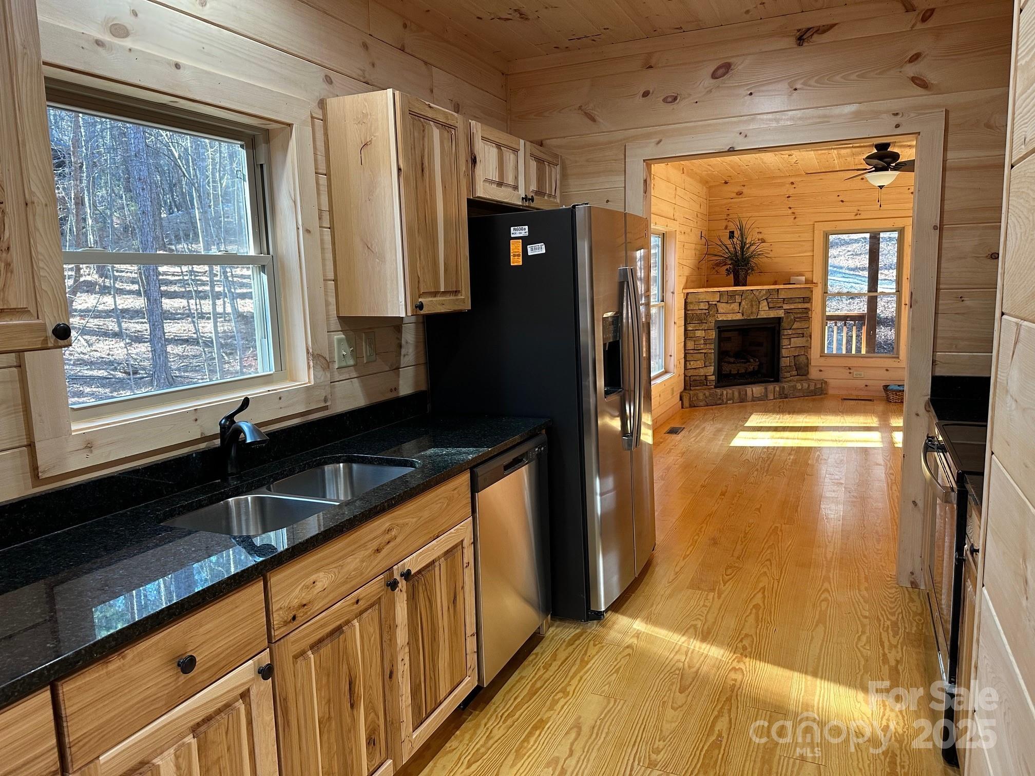 132 Chasewood Drive Rutherfordton, NC 28139 - Photo 25 of 40 a kitchen with granite countertop a sink and a refrigerator