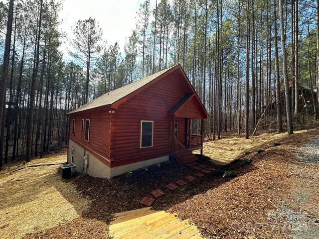 a view of backyard with deck and outdoor seating
