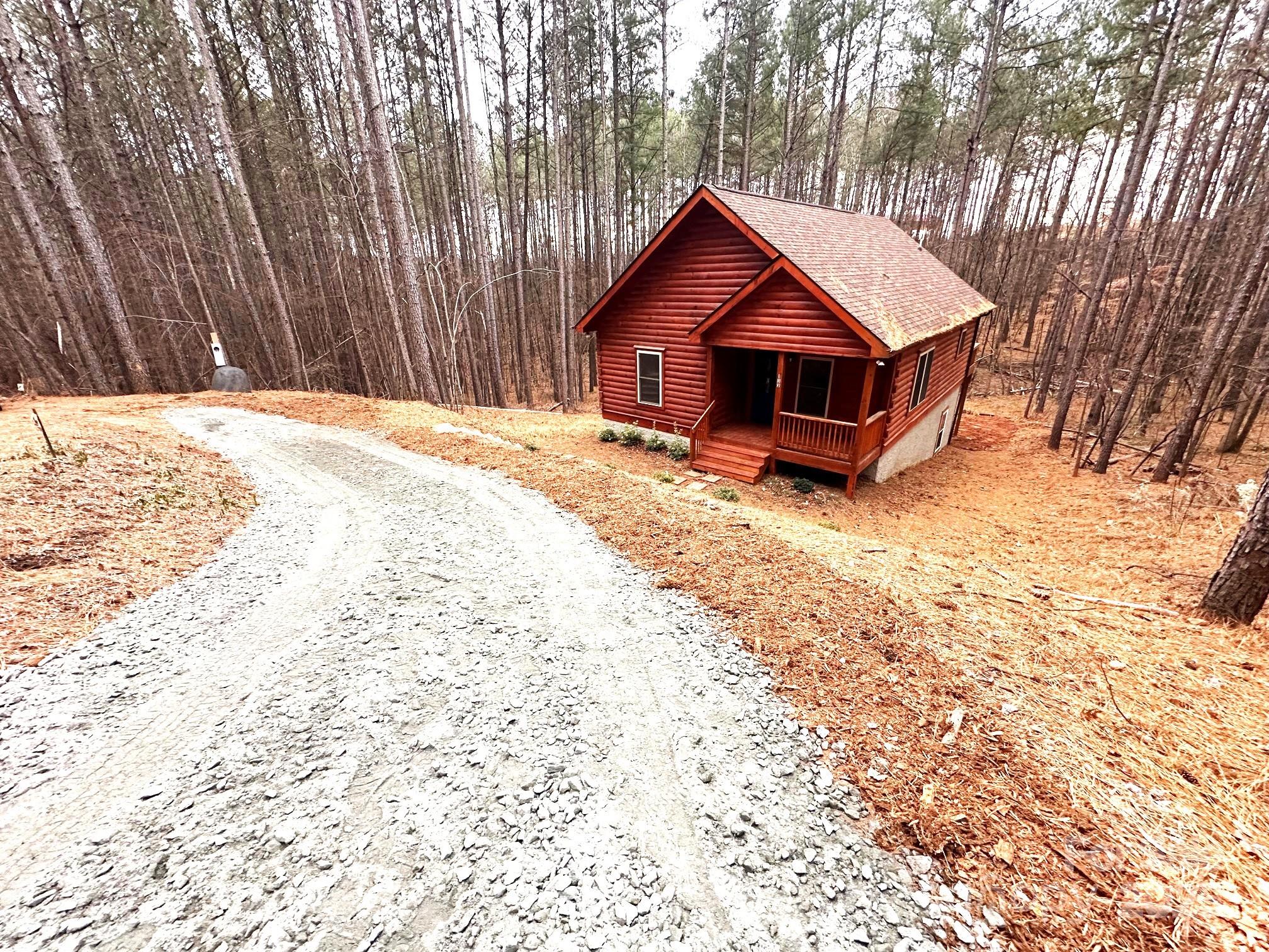 132 Chasewood Drive Rutherfordton, NC 28139 - Photo 5 of 40 a wooden house with trees in the background