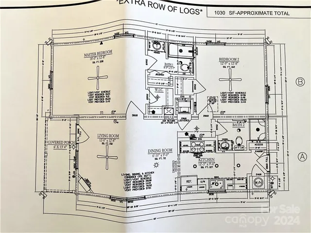 an empty room with windows and fireplace