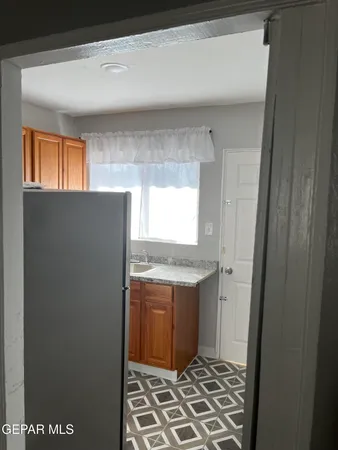 a kitchen with a sink a refrigerator and window