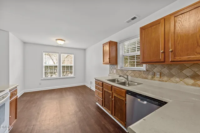 a kitchen with a sink stove and cabinets