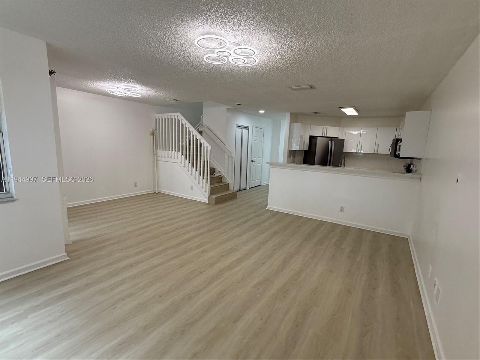 973 Imperial Lake Road, Unit 973 West Palm Beach, FL 33413 - Photo 12 of 28 a view of a kitchen with a sink and a refrigerator