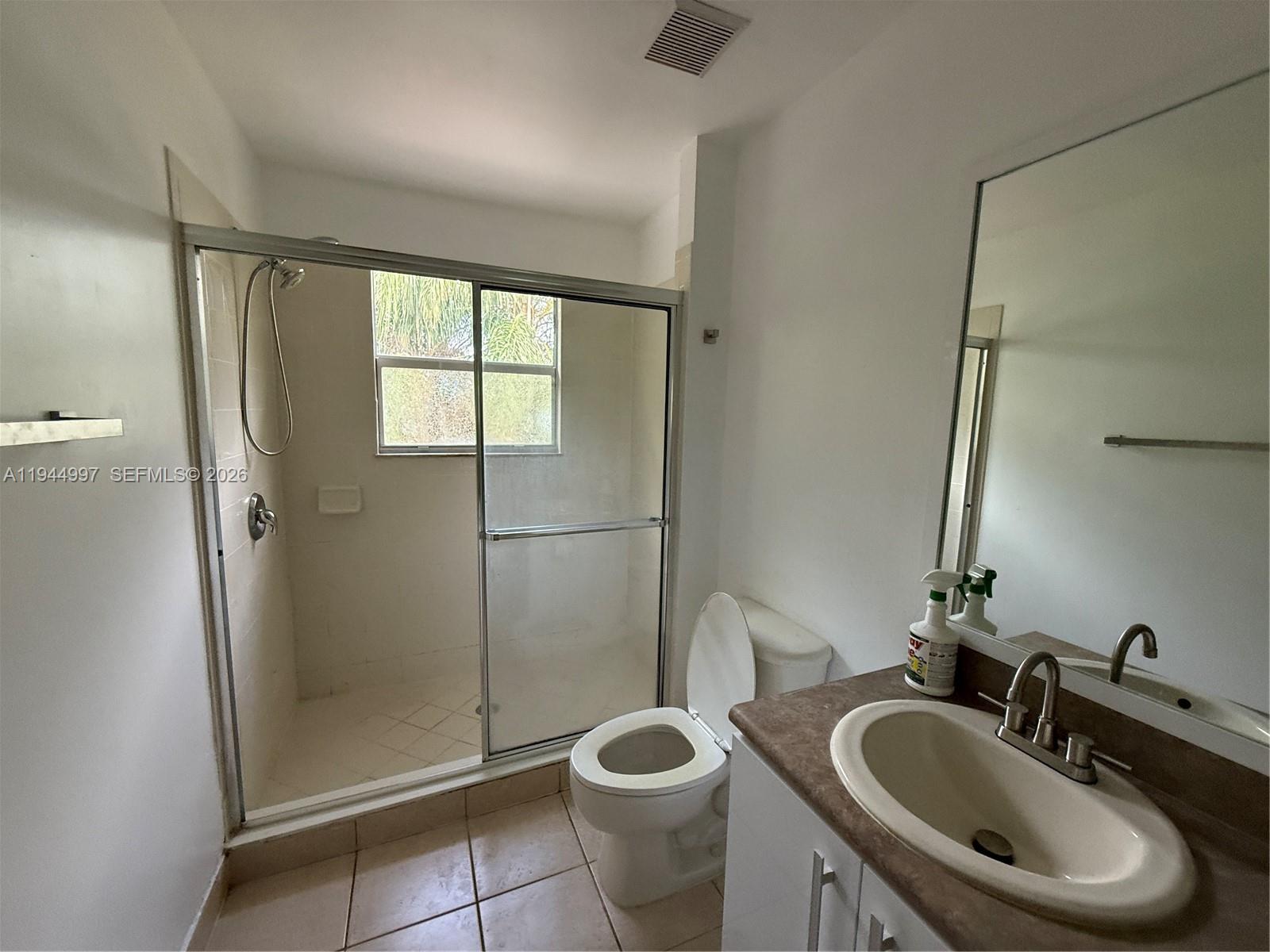 973 Imperial Lake Road, Unit 973 West Palm Beach, FL 33413 - Photo 18 of 28 a bathroom with a toilet sink and shower