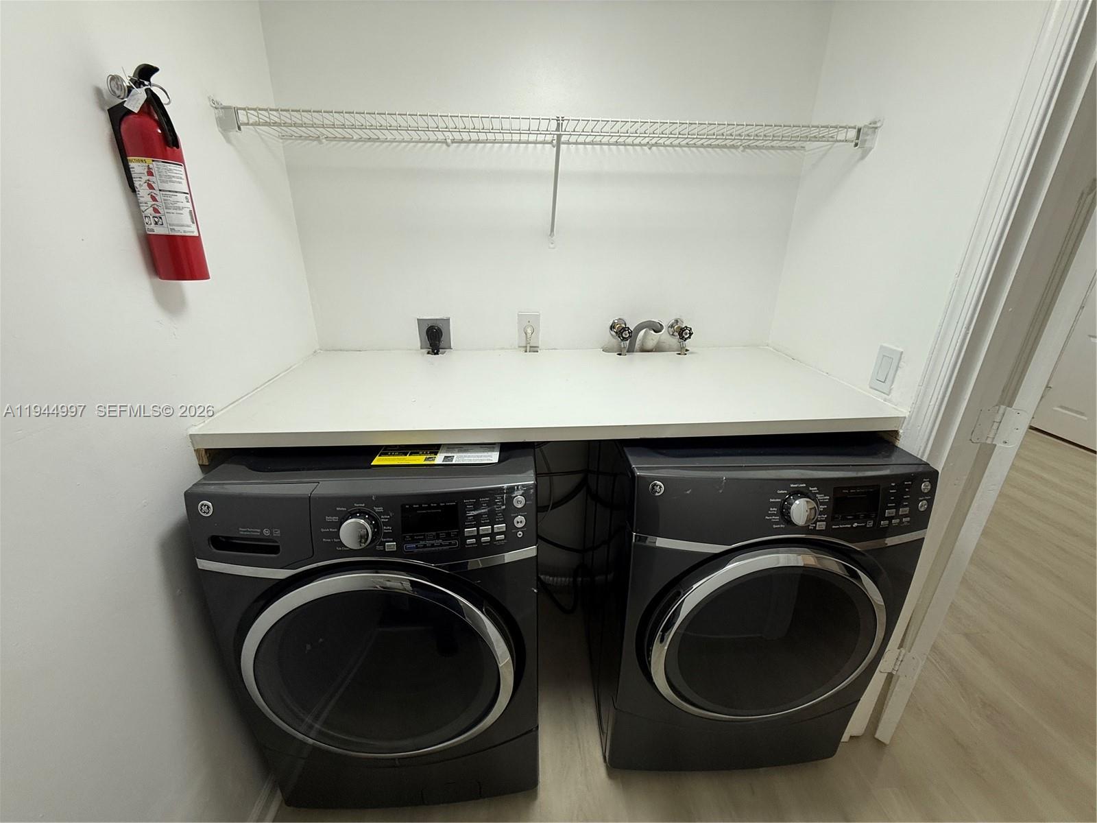 973 Imperial Lake Road, Unit 973 West Palm Beach, FL 33413 - Photo 19 of 28 a utility room with dryer and washer