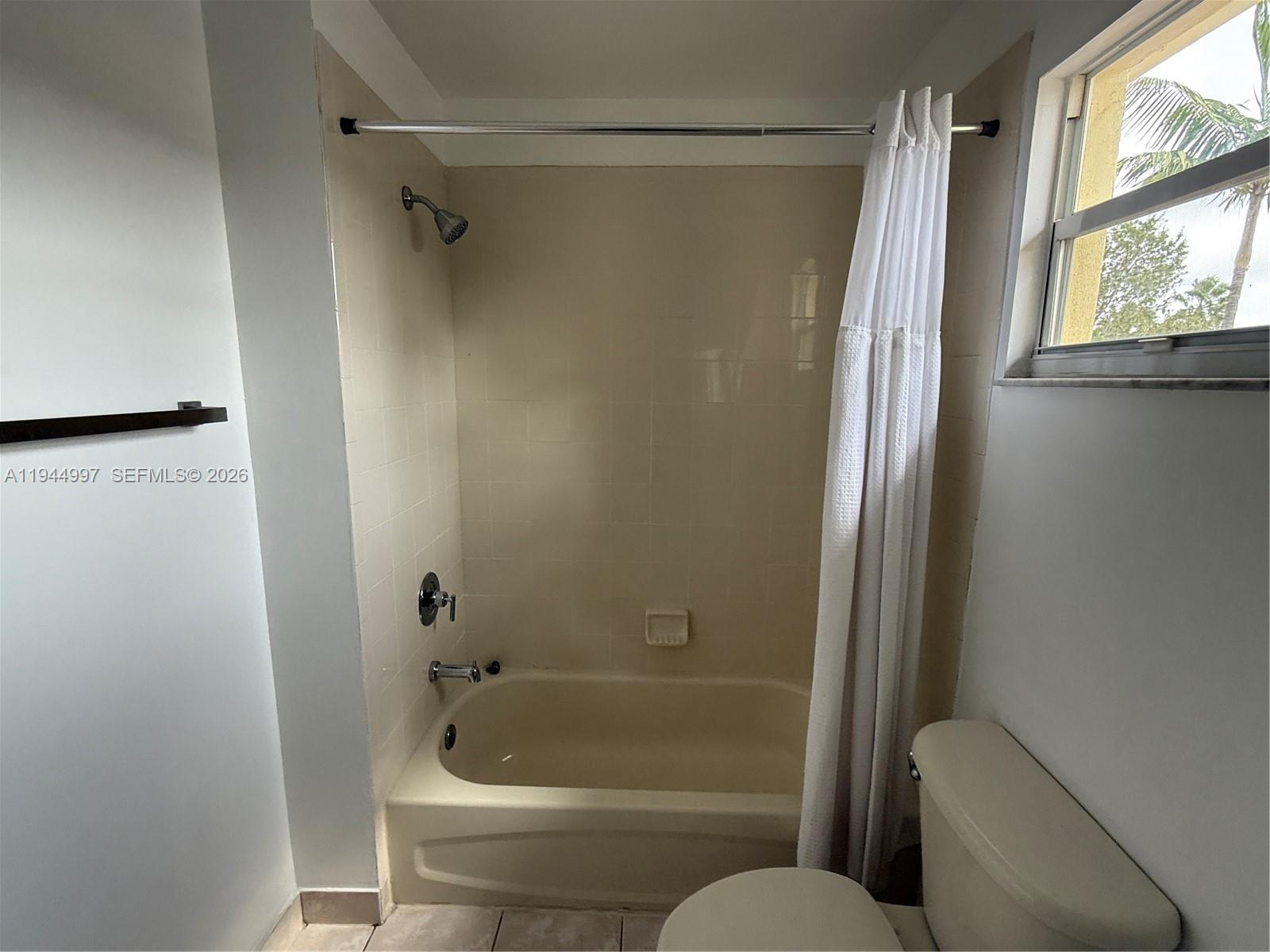 973 Imperial Lake Road, Unit 973 West Palm Beach, FL 33413 - Photo 23 of 28 a bathroom with a tub and a shower