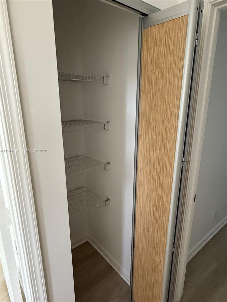 973 Imperial Lake Road, Unit 973 West Palm Beach, FL 33413 - Photo 4 of 28 a bathroom with a glass door shower and closet