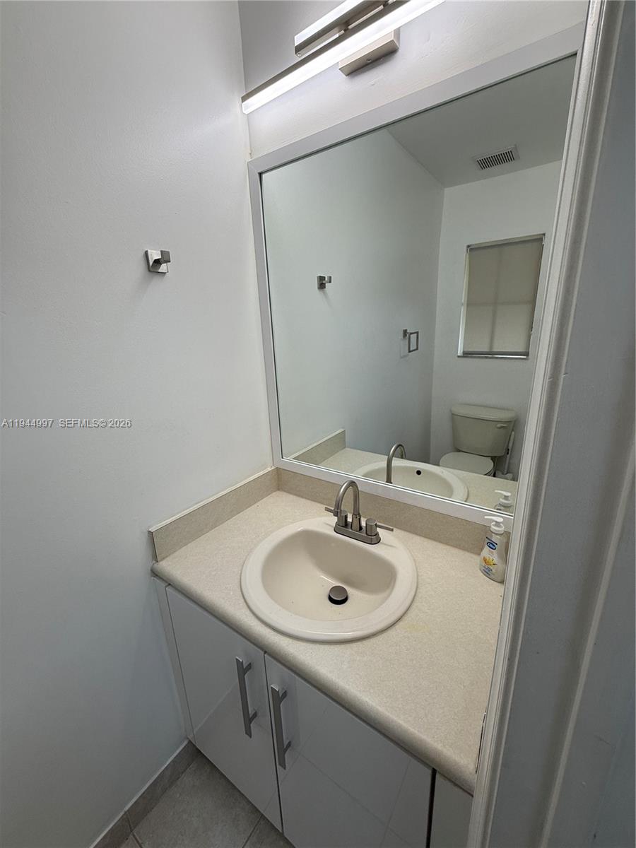 973 Imperial Lake Road, Unit 973 West Palm Beach, FL 33413 - Photo 7 of 28 a bathroom with a sink and a mirror