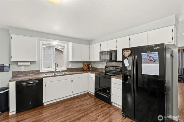 a kitchen with a sink stove and refrigerator