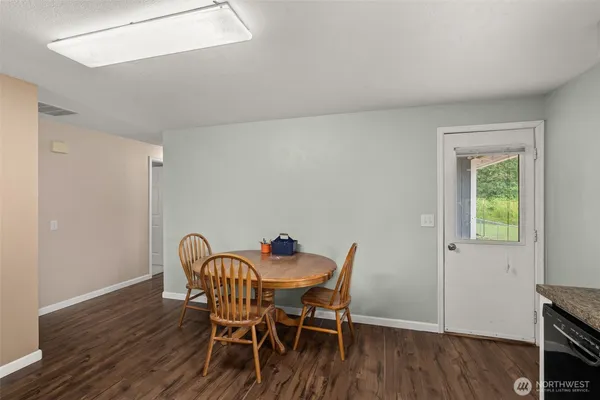 a view of a dining room with furniture and wooden floor