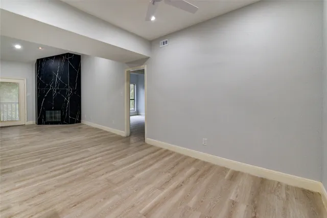 an empty room with wooden floor and closet