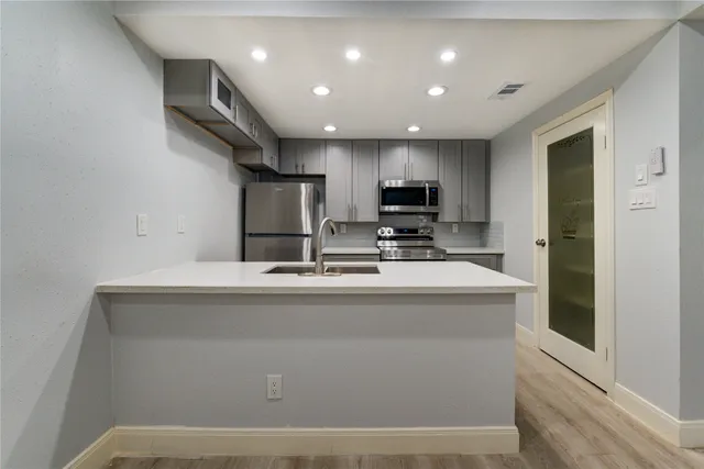 a view of kitchen with refrigerator stove microwave and oven