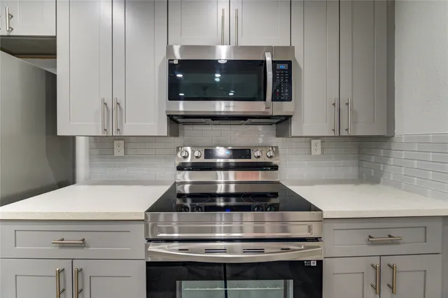 a stove top oven sitting inside of a kitchen