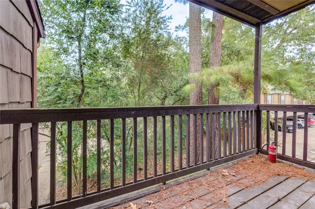 a balcony with wooden floor and outdoor space