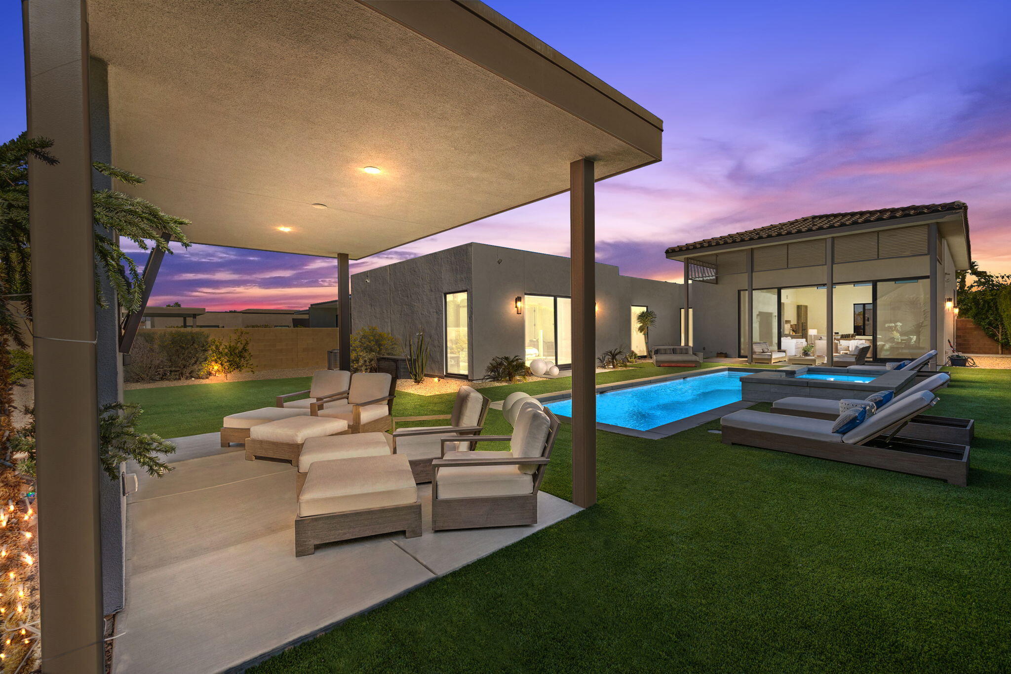 a patio area with couches and potted plants