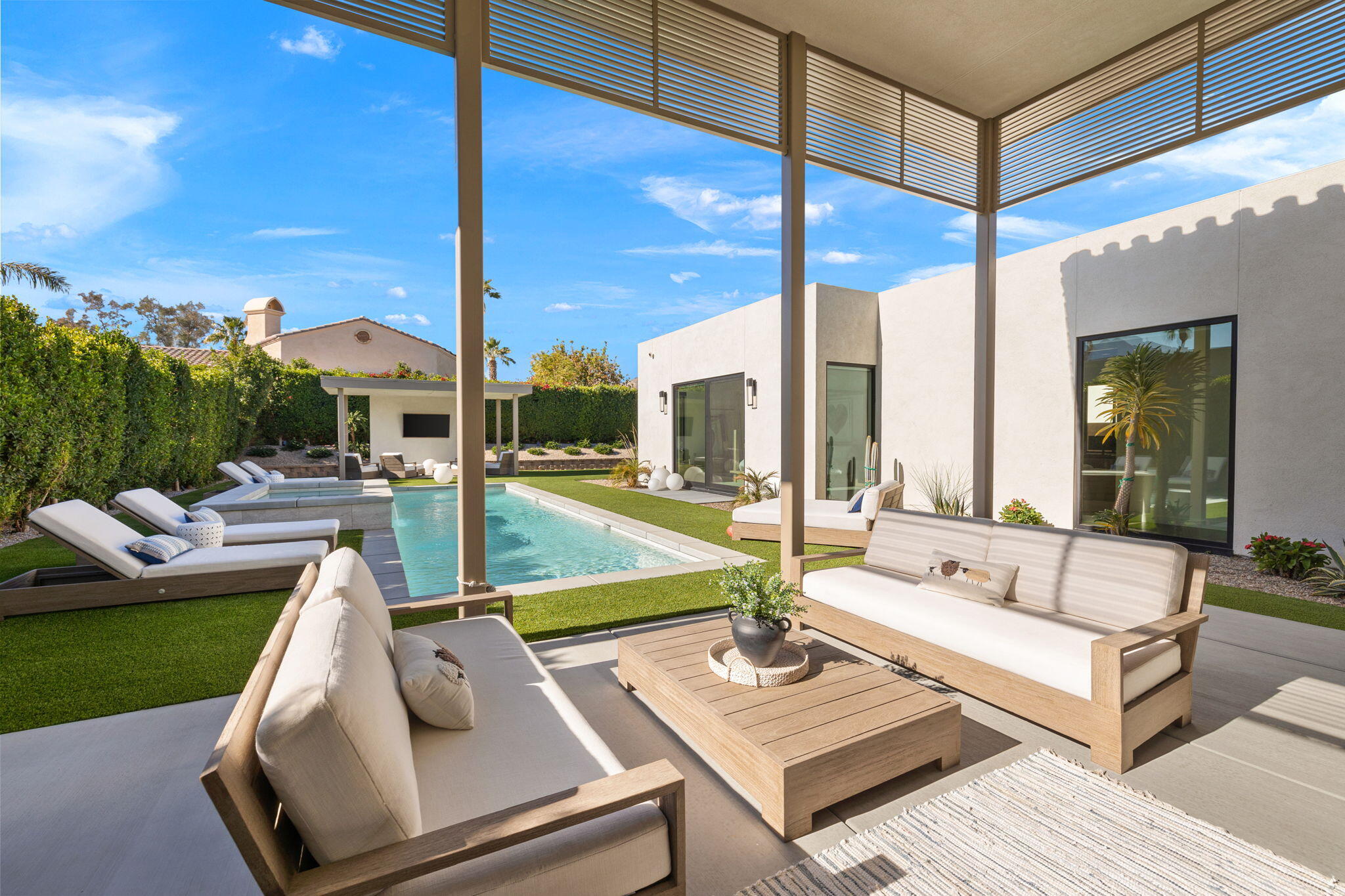 57809 Santo Thomas La Quinta, CA 92253 - Photo 2 of 51 a view of a patio with couches and table potted plants with sky view
