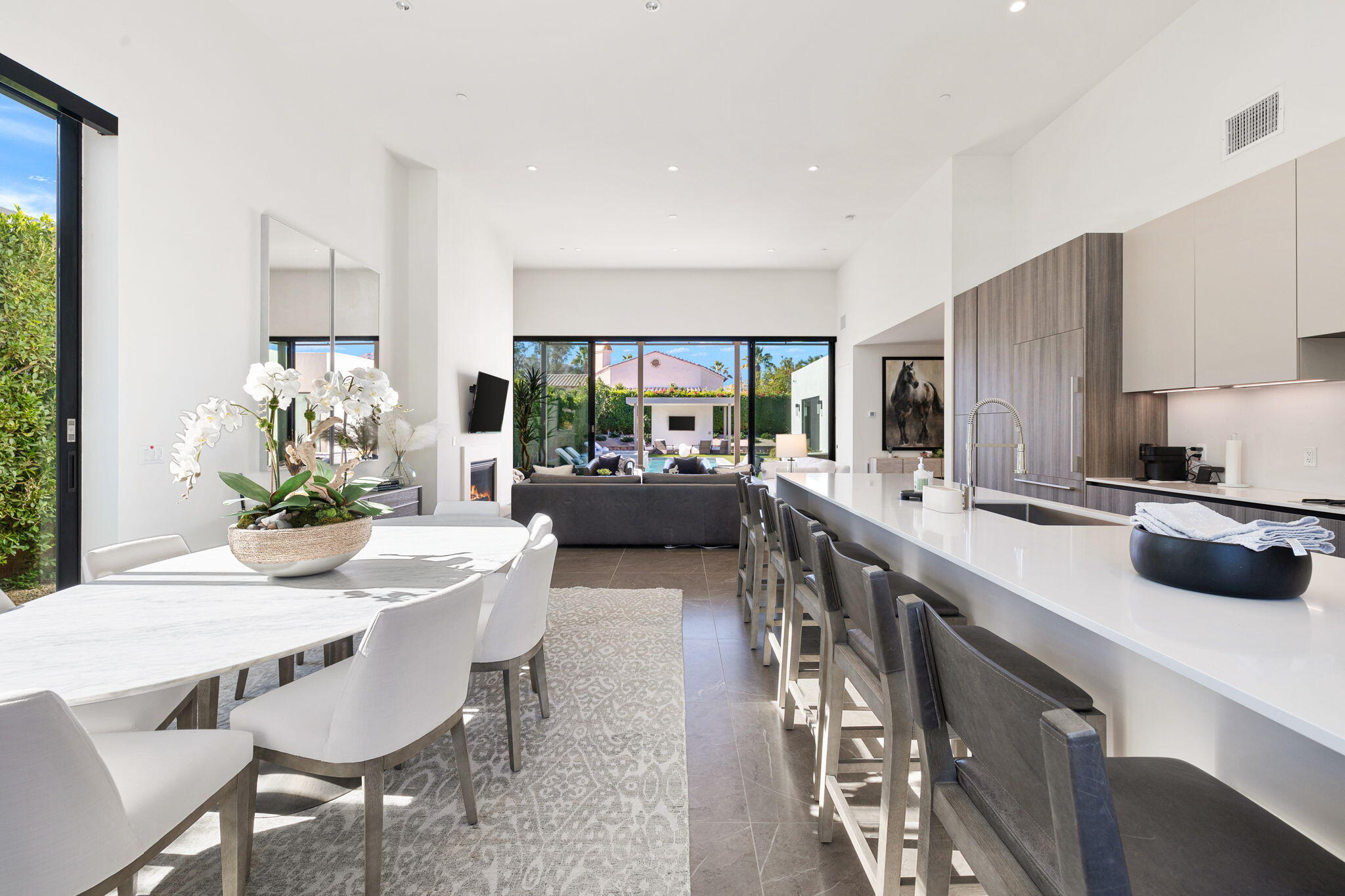 57809 Santo Thomas La Quinta, CA 92253 - Photo 4 of 51 a kitchen with a table chairs stove and cabinets