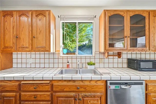 a view of a kitchen with a sink and large window