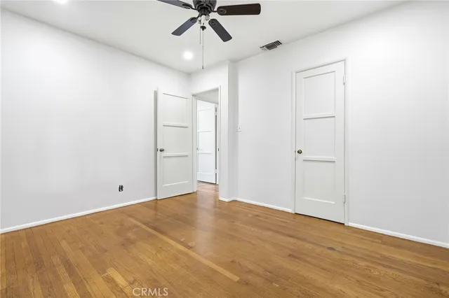 a bedroom with a bed and view of living room