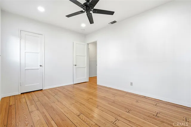 a bedroom with a bed and painting on the wall