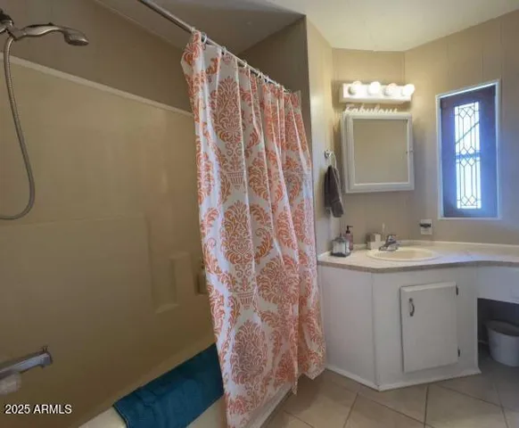 a bathroom with a sink a mirror and a shower