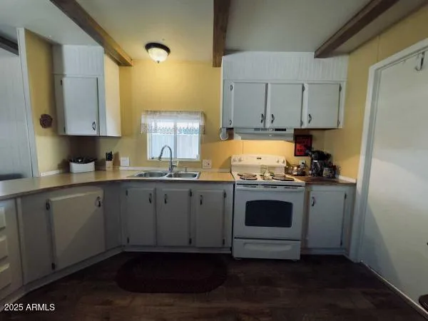 a kitchen with stainless steel appliances granite countertop a stove and white cabinets