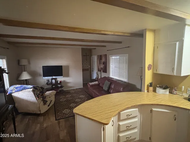 a en suite bathroom with a granite countertop sink and a mirror