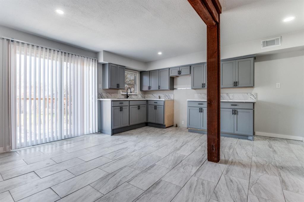 4412 Utah Avenue Dallas, TX 75216 - Photo 4 of 11 a kitchen with stainless steel appliances granite countertop a stove top oven sink and cabinets
