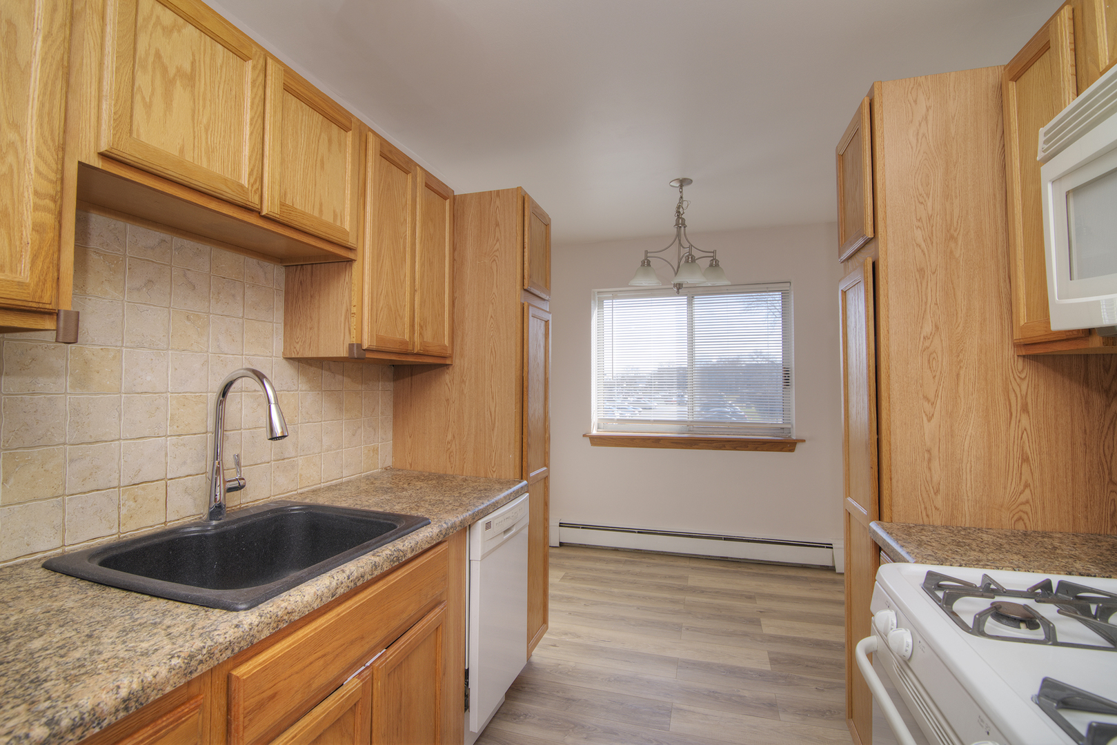 1301 South Finley Road, Unit 204 Lombard, IL 60148 - Photo 15 of 24 a kitchen with stainless steel appliances granite countertop a sink stove and cabinets