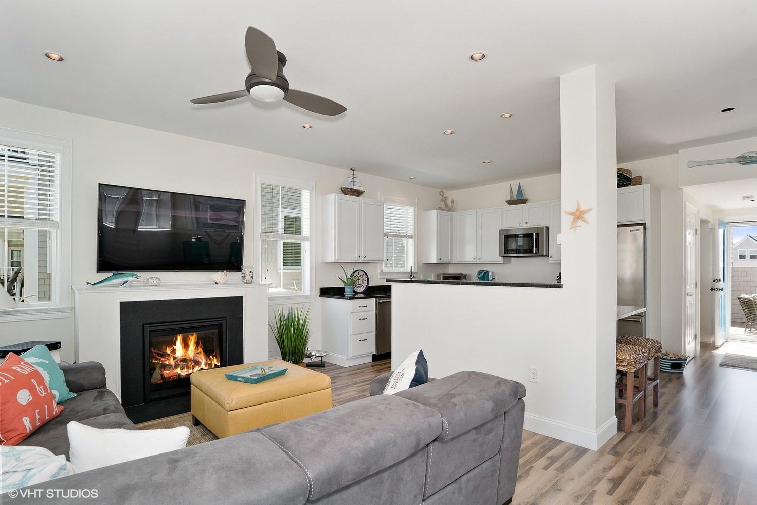 61 Old Wharf Road, Unit 62 Dennis Port, MA 02639 - Photo 11 of 25 a living room with furniture fireplace and flat screen tv