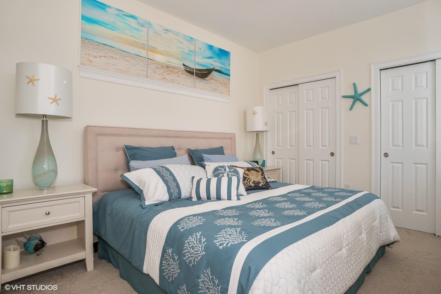 61 Old Wharf Road, Unit 62 Dennis Port, MA 02639 - Photo 12 of 25 a bedroom with a bed and a lamp on the dresser