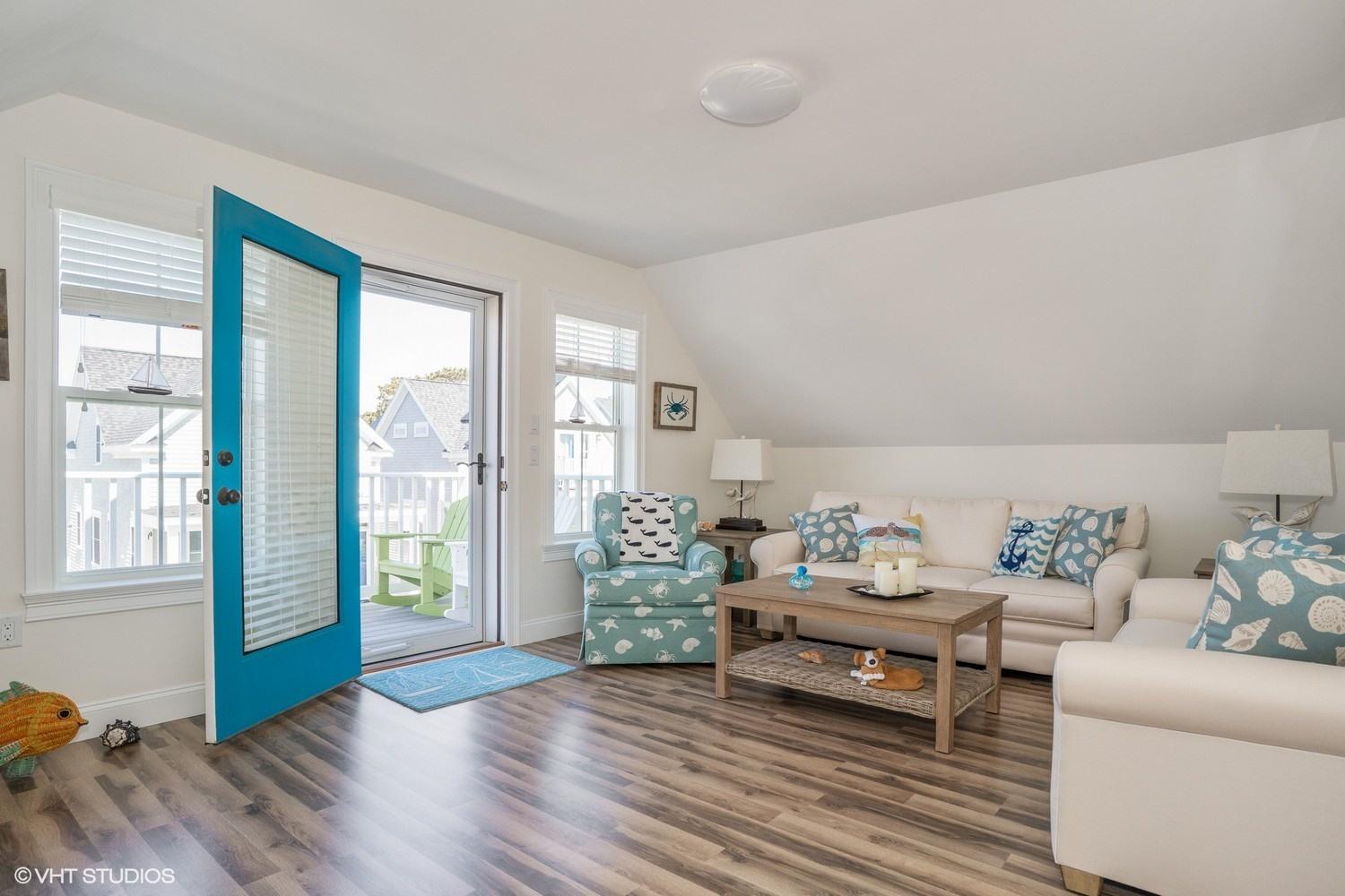 61 Old Wharf Road, Unit 62 Dennis Port, MA 02639 - Photo 14 of 25 a living room with furniture and a window