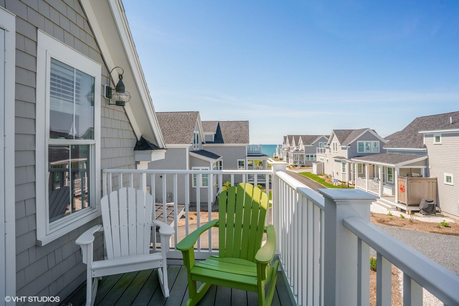 61 Old Wharf Road, Unit 62 Dennis Port, MA 02639 - Photo 15 of 25 a view of a chair and tables in the balcony
