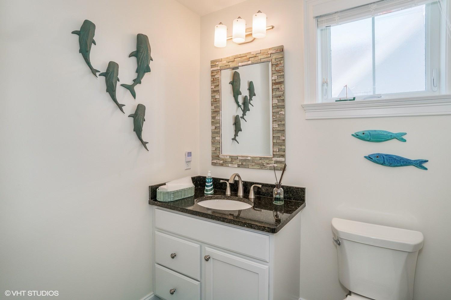 61 Old Wharf Road, Unit 62 Dennis Port, MA 02639 - Photo 17 of 25 a bathroom with a granite countertop sink and a mirror