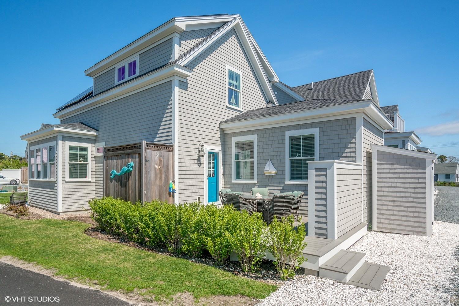 61 Old Wharf Road, Unit 62 Dennis Port, MA 02639 - Photo 18 of 25 a front view of a house with a yard