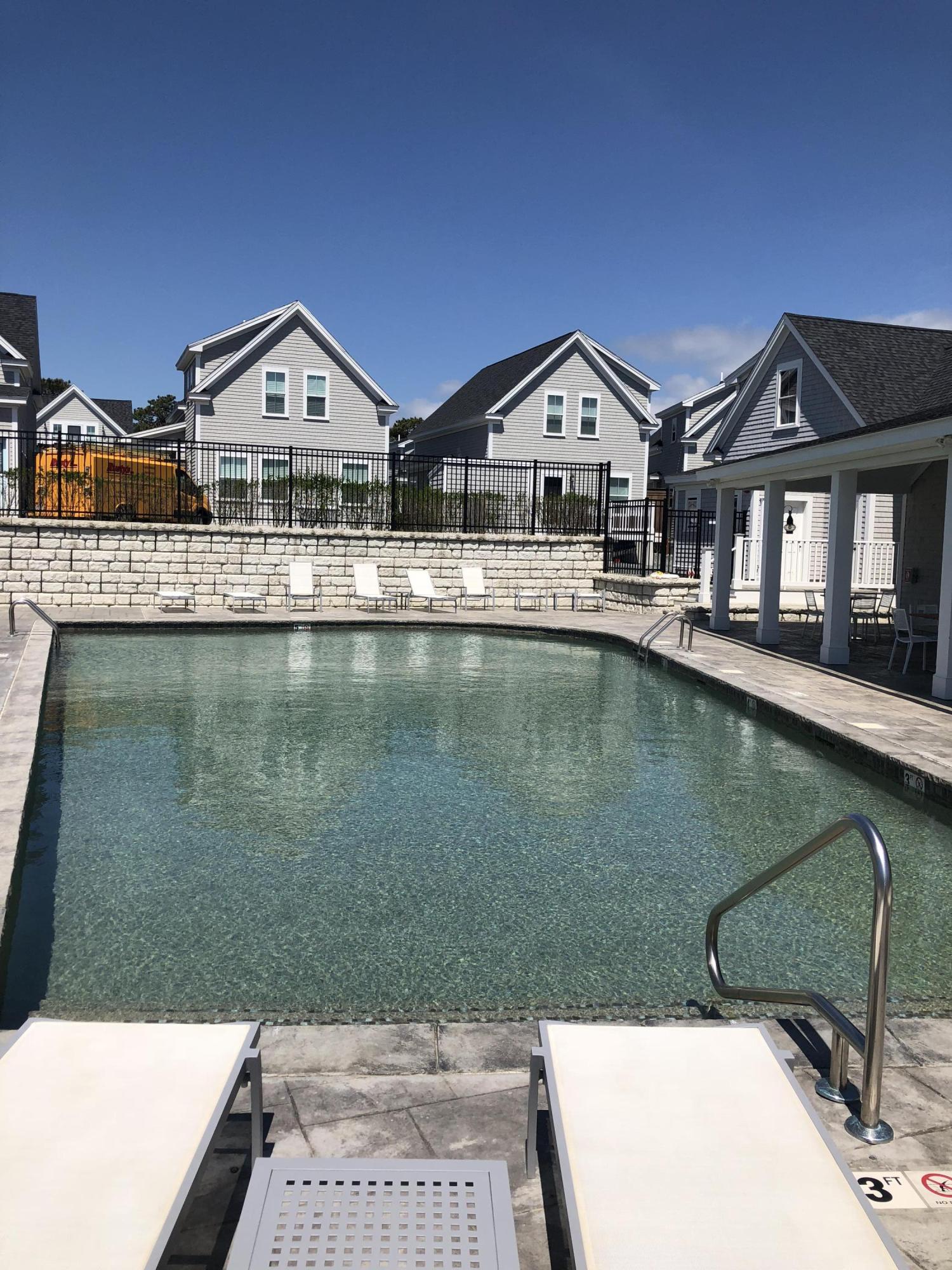 61 Old Wharf Road, Unit 62 Dennis Port, MA 02639 - Photo 19 of 25 a view of house with outdoor space and sitting area