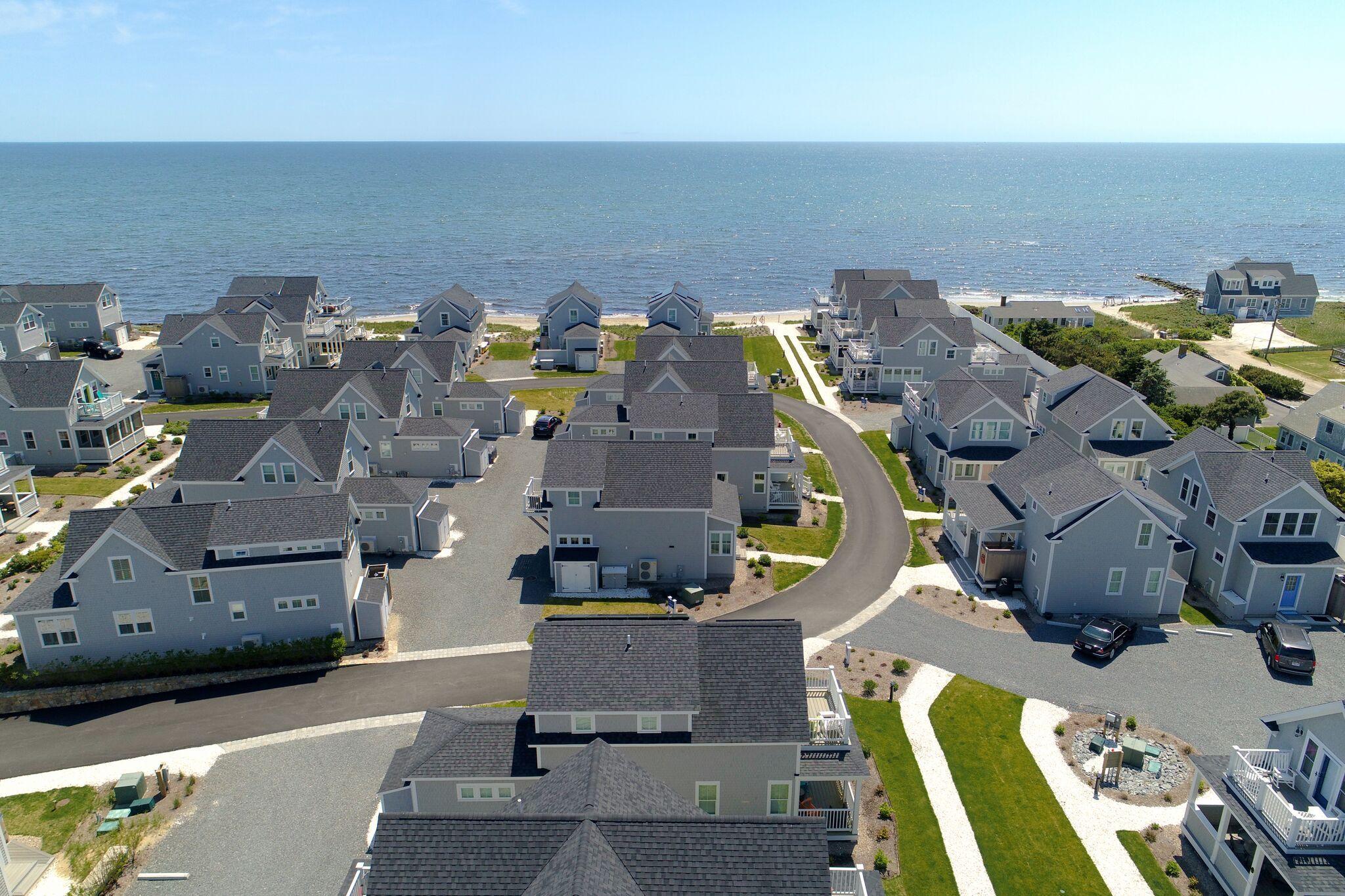 61 Old Wharf Road, Unit 62 Dennis Port, MA 02639 - Photo 21 of 25 an aerial view of a house with a swimming pool
