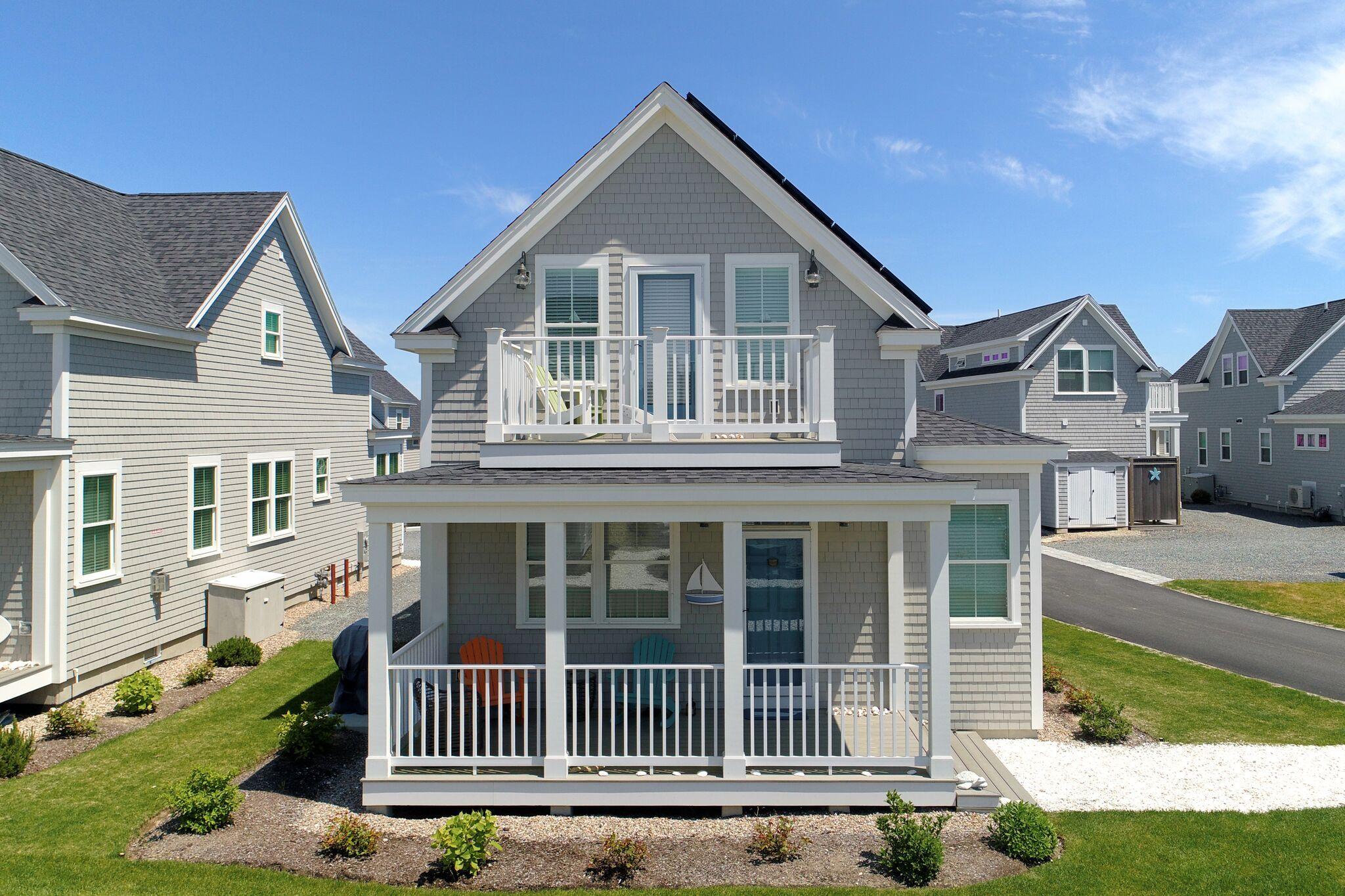 61 Old Wharf Road, Unit 62 Dennis Port, MA 02639 - Photo 3 of 25 a front view of a house with a yard