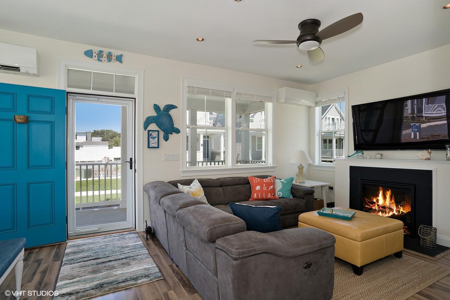 61 Old Wharf Road, Unit 62 Dennis Port, MA 02639 - Photo 8 of 25 a living room with furniture and a fireplace